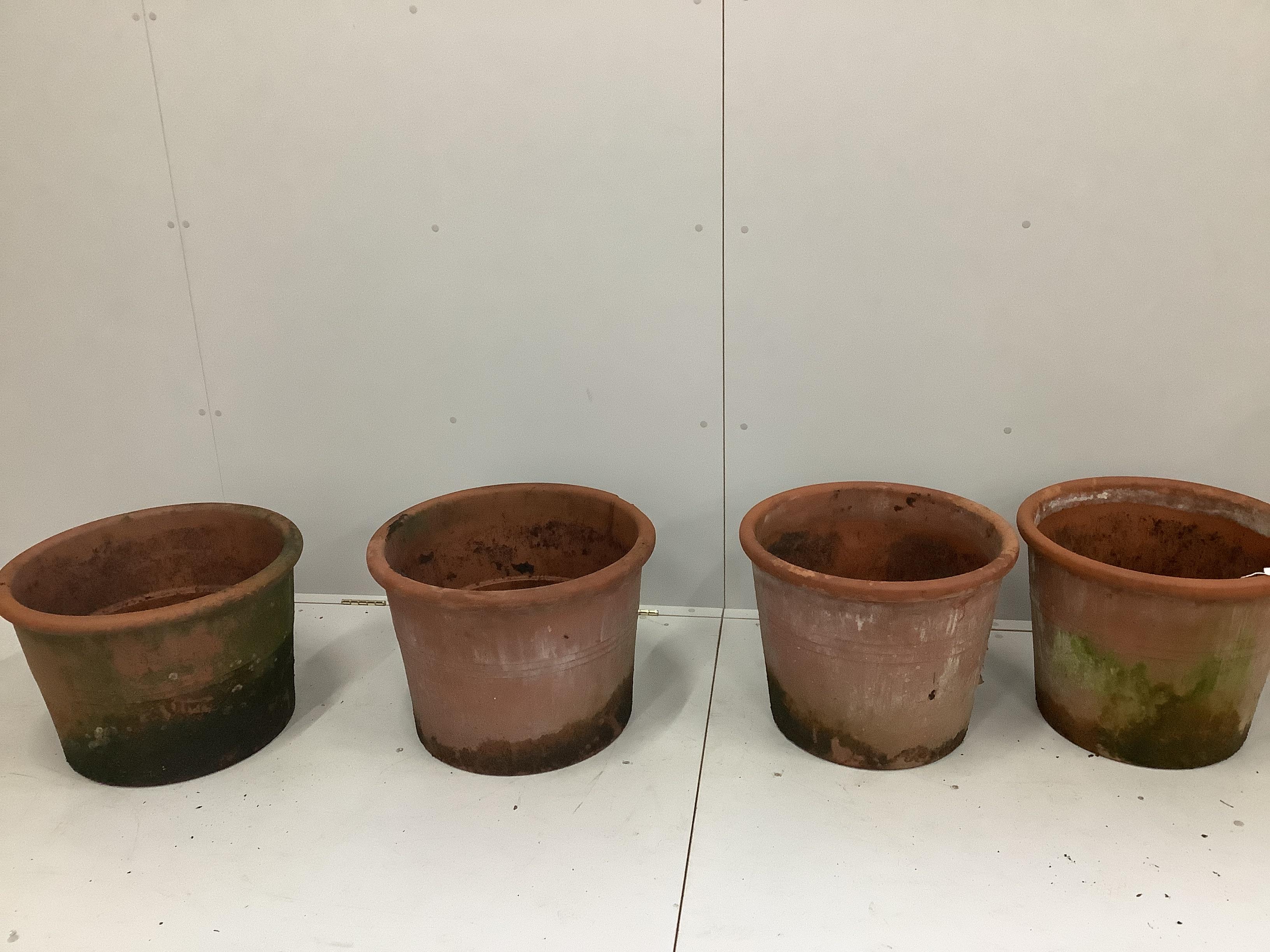 A pair of terracotta garden pots, diameter 50cm and another similar near pair of pots, diameter 55cm